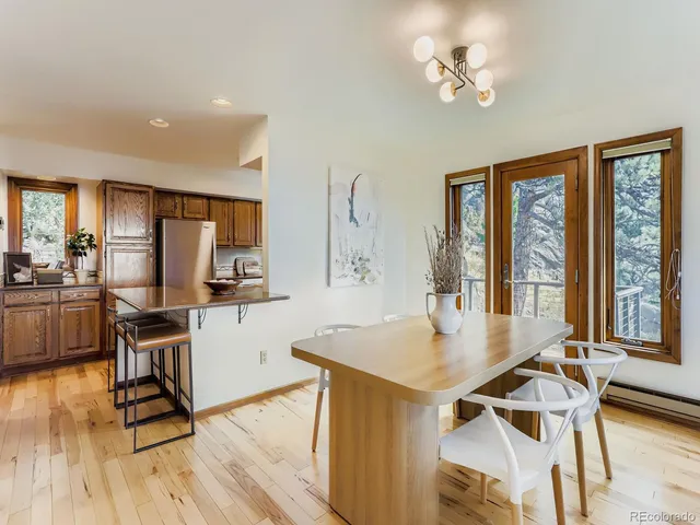 a view of a dining room with furniture window and wooden floor