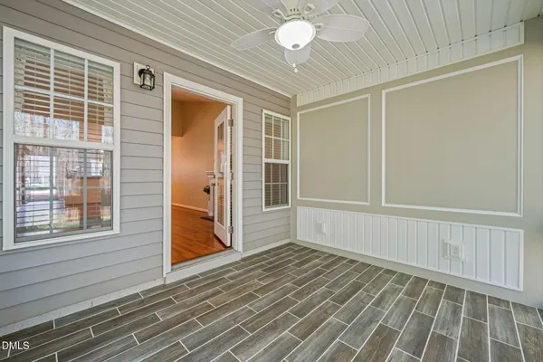 en empty room with window and wooden floor
