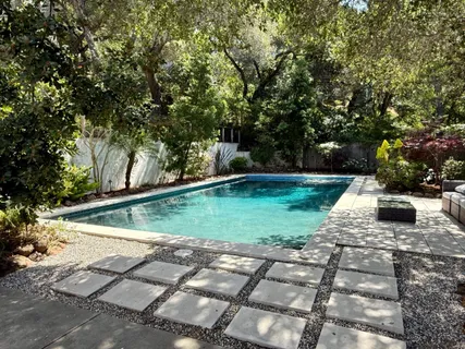 a view of a backyard with large trees