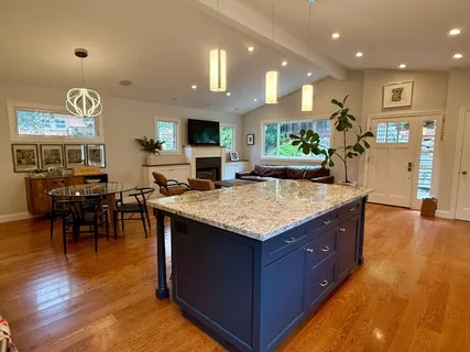 a kitchen with kitchen island granite countertop a table and chairs in it