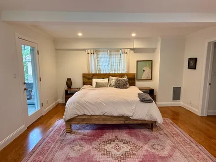 a bedroom with a bed and wooden floor