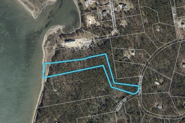 172 Vineyard Road Barnstable, MA 02635 - Photo 4 of 6 an empty room with wooden floor and bench