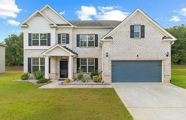 a front view of a house with yard