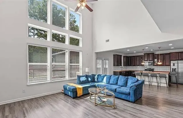 a living room with furniture and a wooden floor