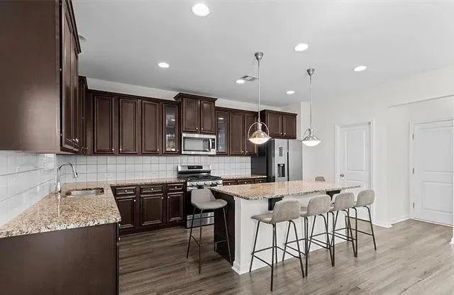 a kitchen with lots of clutter and cabinets