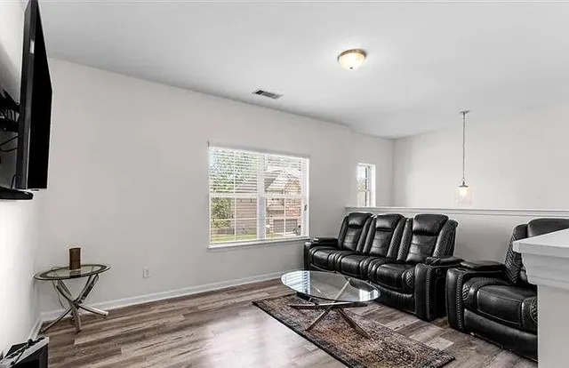 a bedroom with a bed window and a flat screen tv
