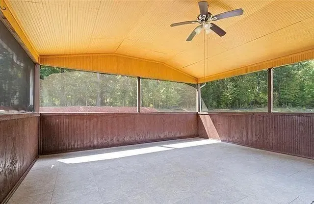 a front view of a house with a garden and yard