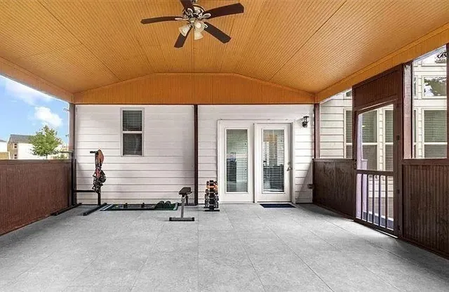a view of a house with a backyard and a patio