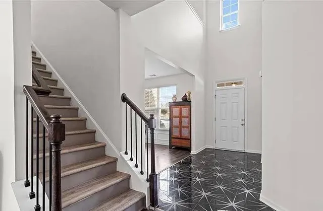 a view of entryway and hall with wooden floor
