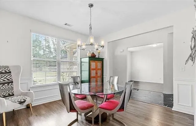 a view of a dining room with furniture window and wooden floor
