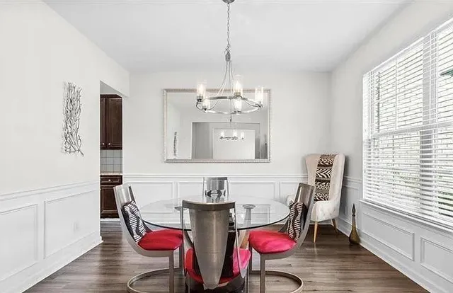 a view of a dining room with furniture and wooden floor
