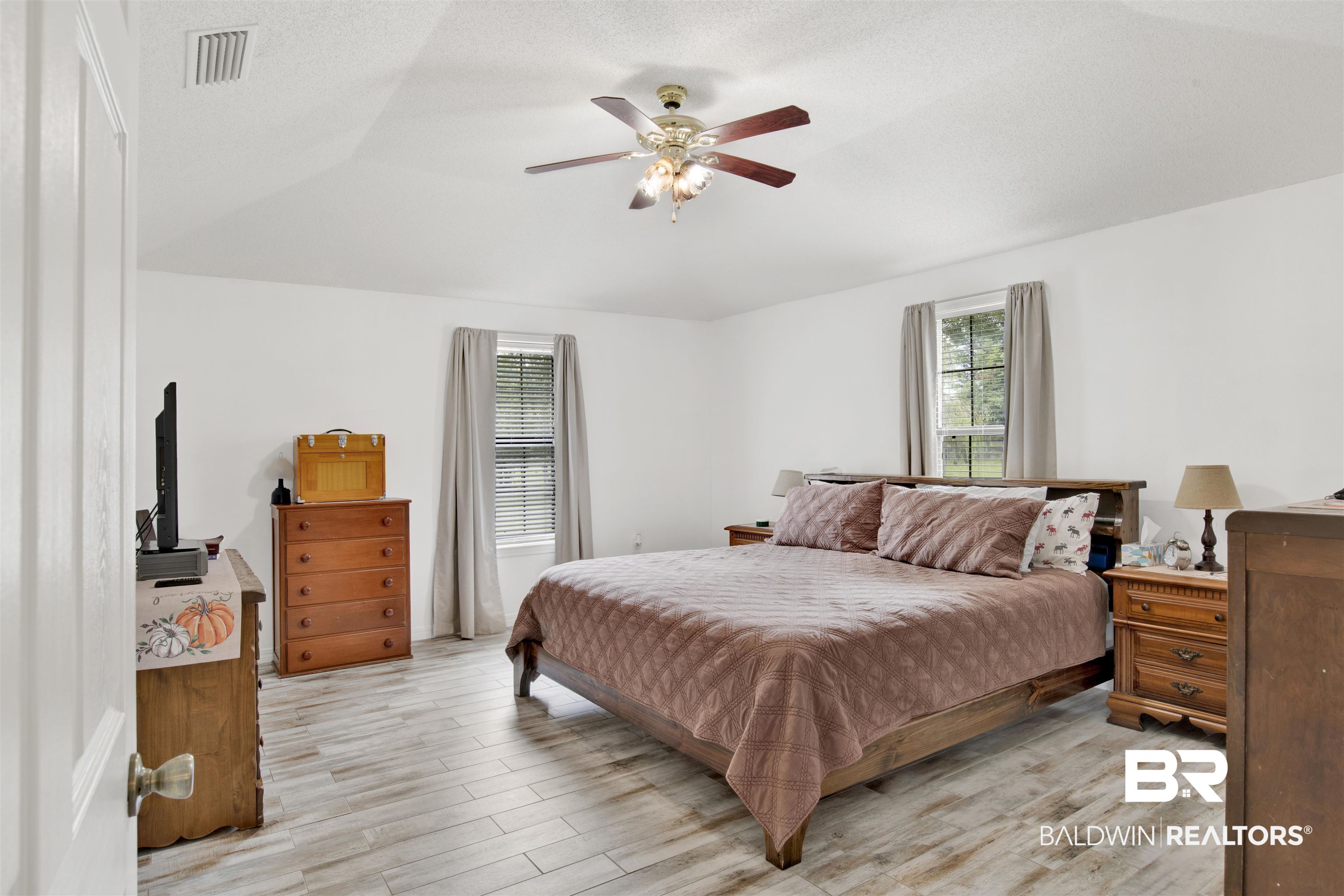 54563 Splinter Hill Road Perdido, AL 36562 - Photo 19 of 29 Bedroom featuring light wood-type flooring, ceiling fan, and vaulted ceiling