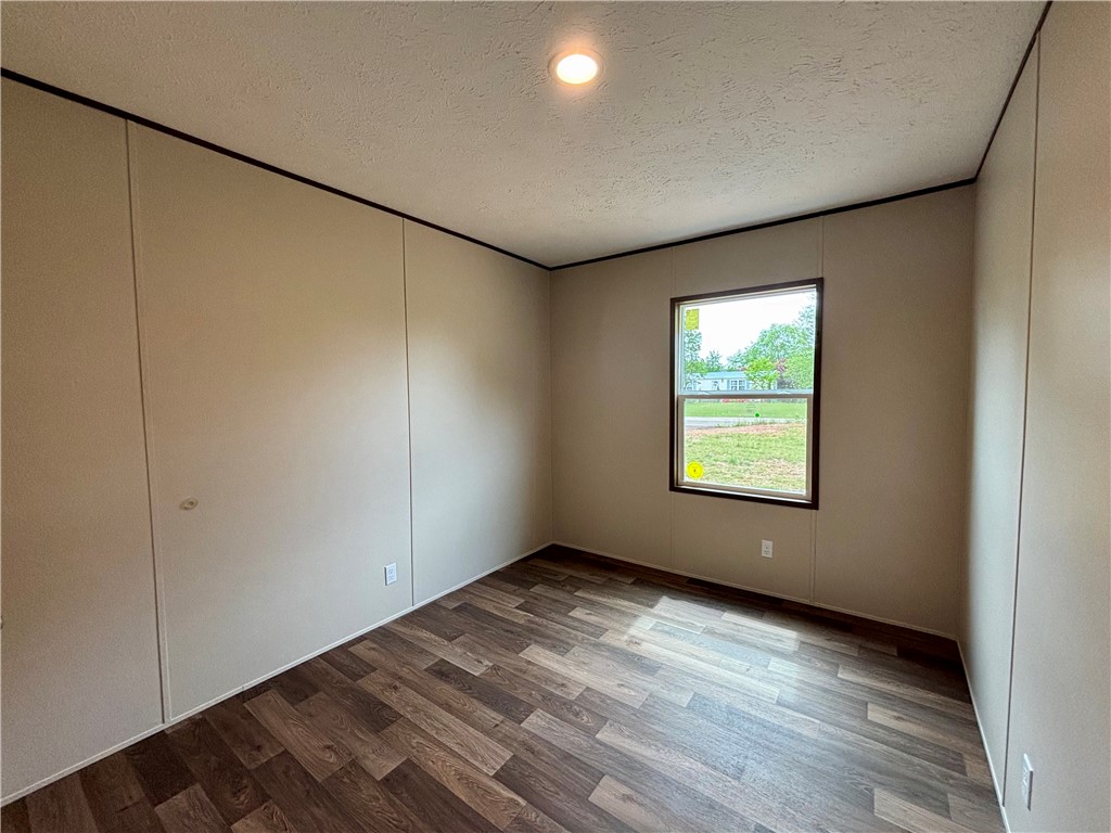 703 Double Springs Road Townville, SC 29689 - Photo 11 of 22 This cozy bedroom features durable flooring and a bright window, creating a serene personal retreat.