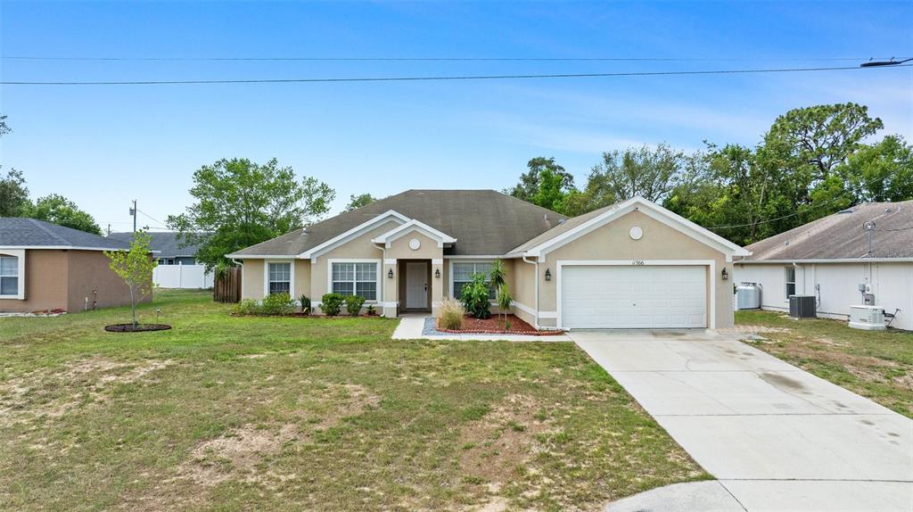 11366 Riddle Drive Spring Hill, FL 34609 - Photo 1 of 1 a front view of a house with a yard and garage