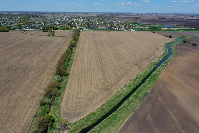 a view of a city street with a yard