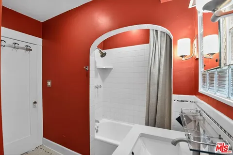 a bathroom with a tub and shower