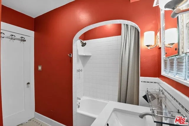 a bathroom with a tub and shower