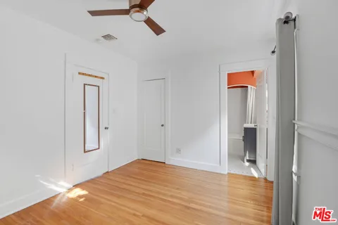 a view of a room with wooden floor and closet