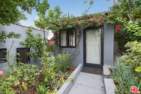 front view of a house with a potted plant