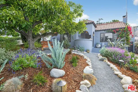 a view of a house with a yard and a garden