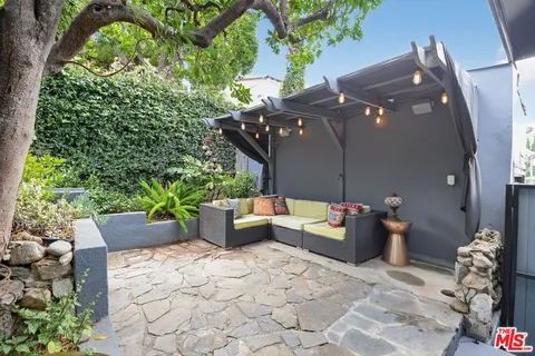 a view of a patio with couches and potted plants