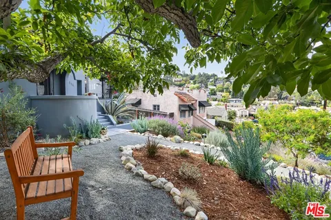 a backyard of a house with table and chairs