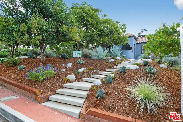 a view of a backyard with chairs and fire pit