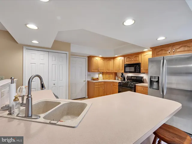 a kitchen with kitchen island a sink and appliances