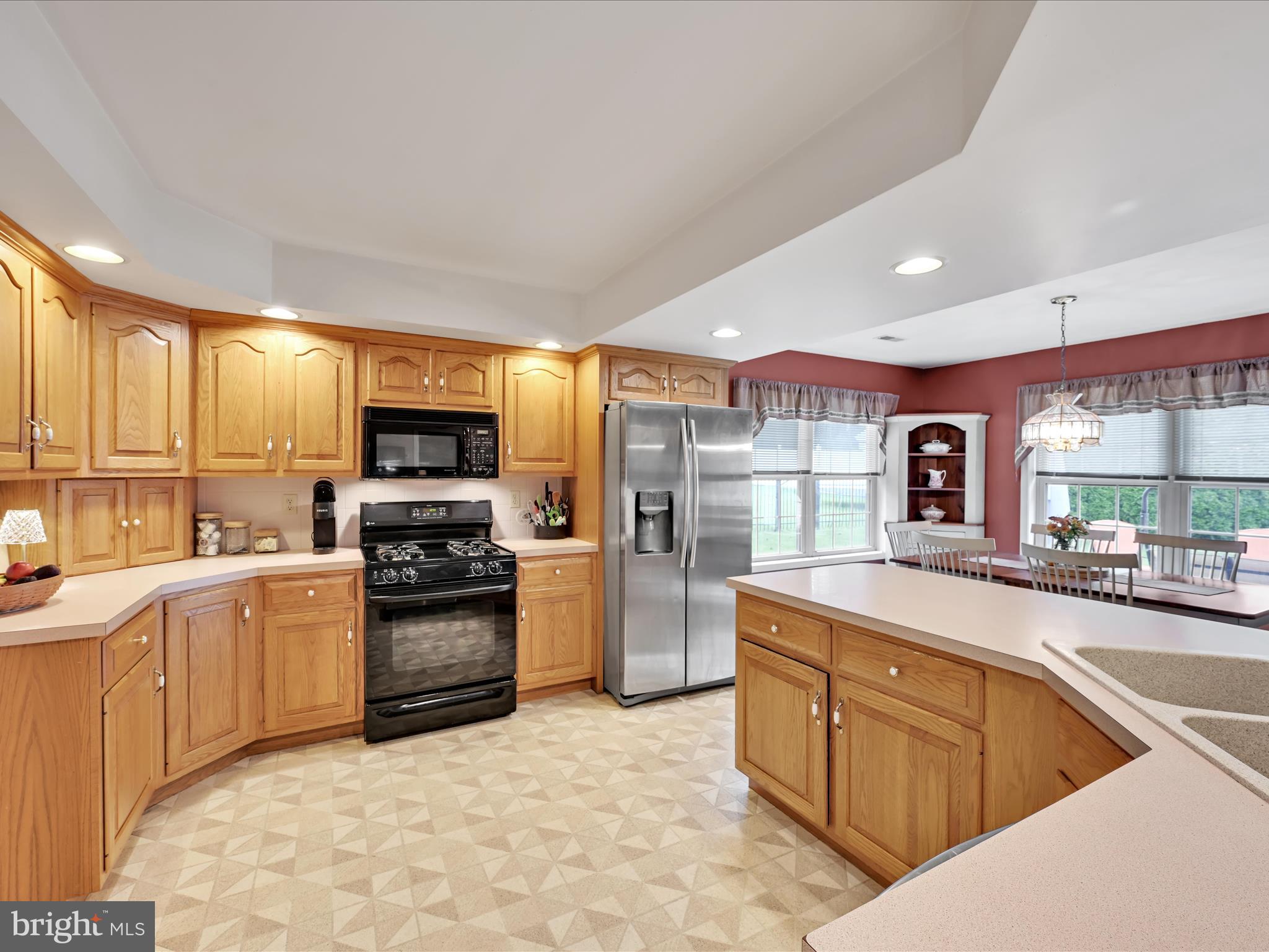 21 Silver Creek Road Lititz, PA 17543 - Photo 15 of 37 a kitchen with stainless steel appliances granite countertop a sink stove refrigerator and cabinets
