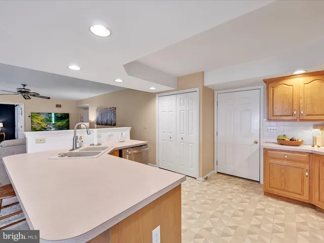 a room with kitchen island a sink a stove and refrigerator
