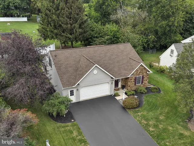 an aerial view of a house with a yard and a fountain
