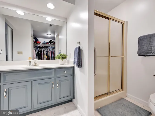 a bathroom with a double vanity sink a mirror and a toilet