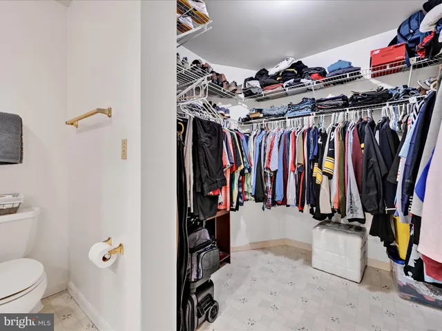 a view of walk in closet with clothes