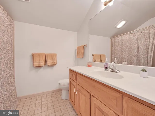a bedroom with a large bed a book shelf and a window