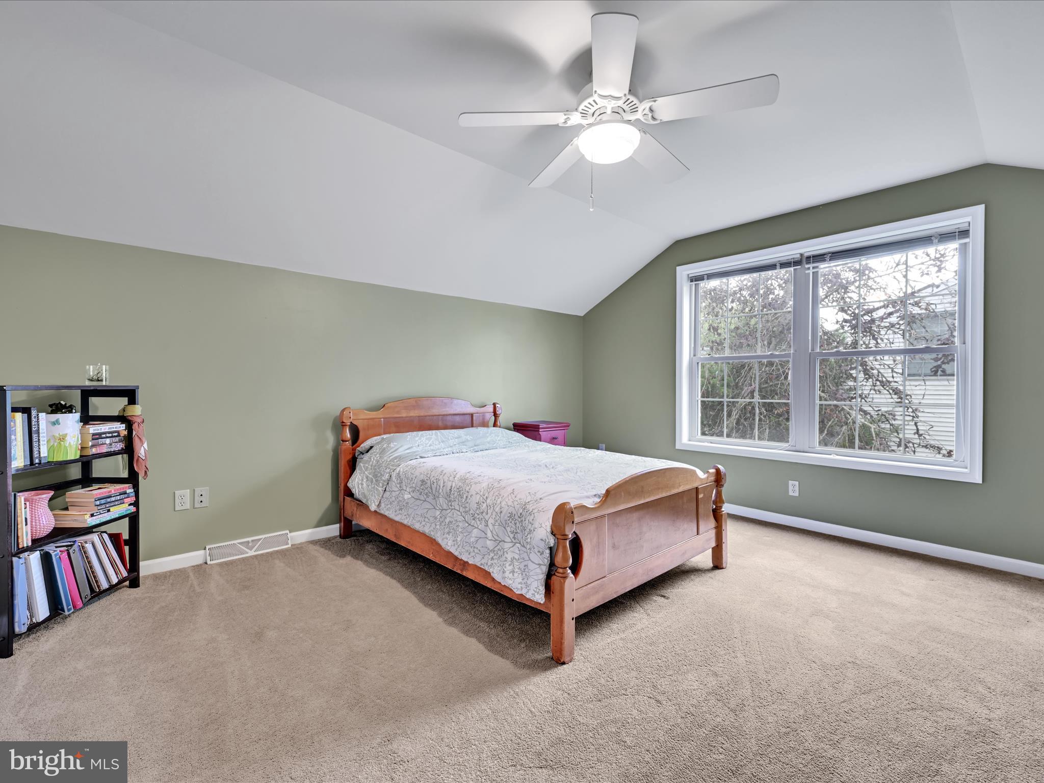 21 Silver Creek Road Lititz, PA 17543 - Photo 31 of 37 a bedroom with a large bed a book shelf and a window