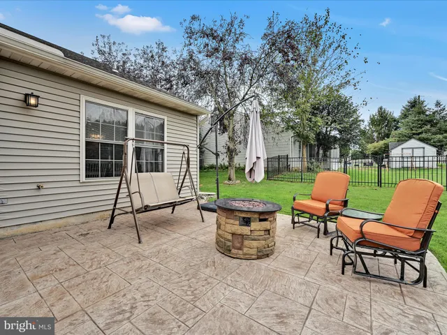 a view of a backyard with sitting area and garden