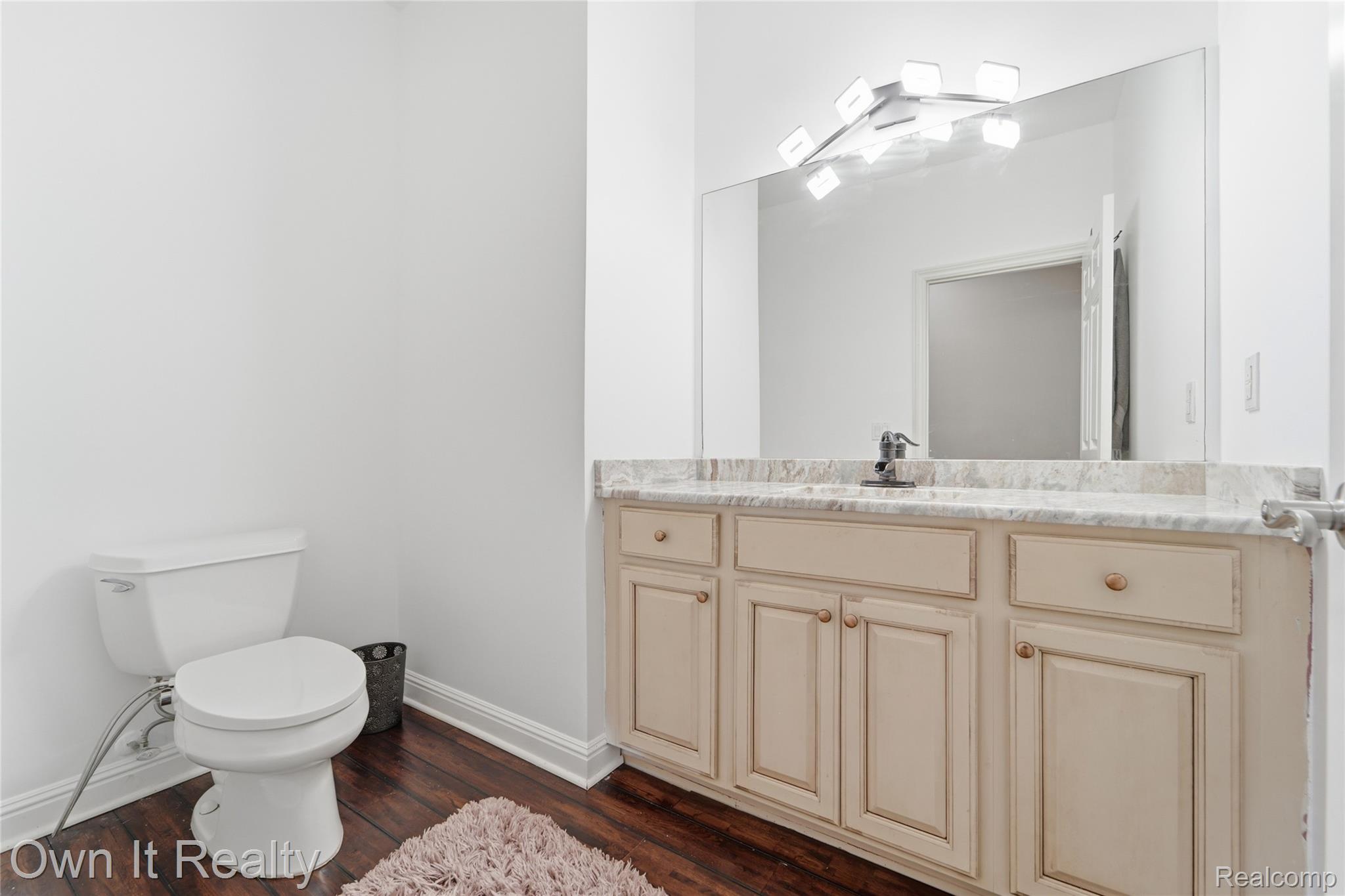 48280 Gladstone Road Canton, MI 48188 - Photo 27 of 59 Bathroom vanity featuring a stone countertop, an integrated sink, and an undermount cabinet with drawers and doors