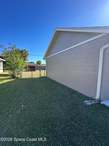 a backyard of a house with lots of green space and plants