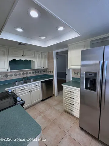 a kitchen with a sink stove and refrigerator