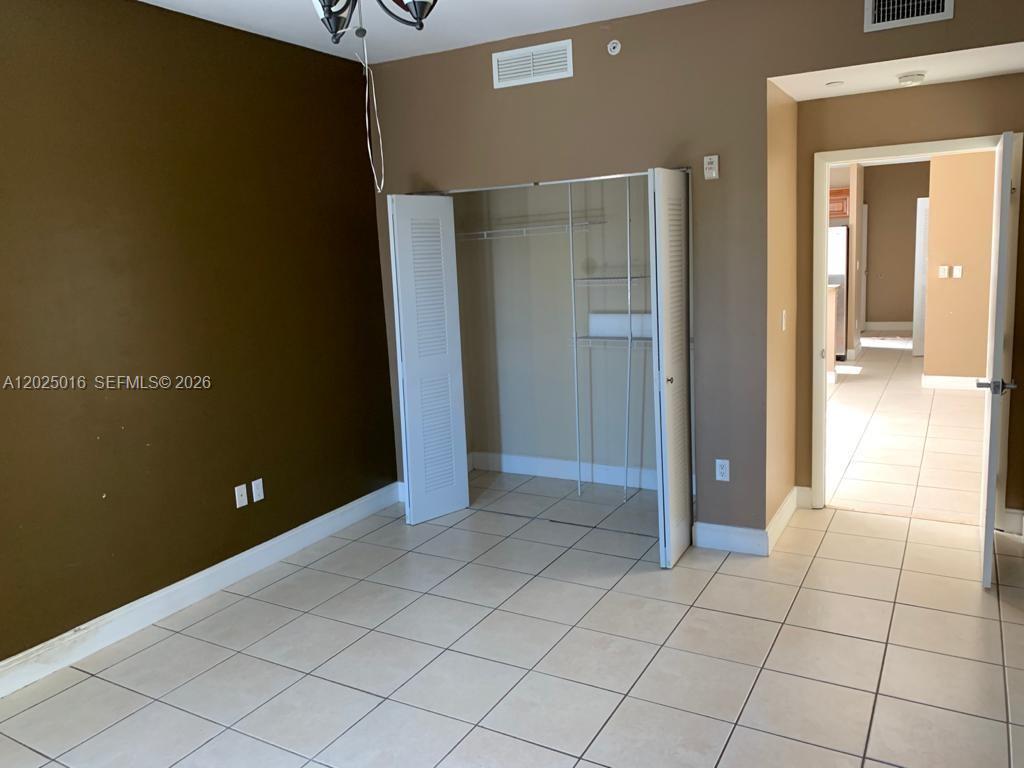 400 Southwest 2nd Street, Unit 201 Miami, FL 33130 - Photo 8 of 12 en empty room with windows