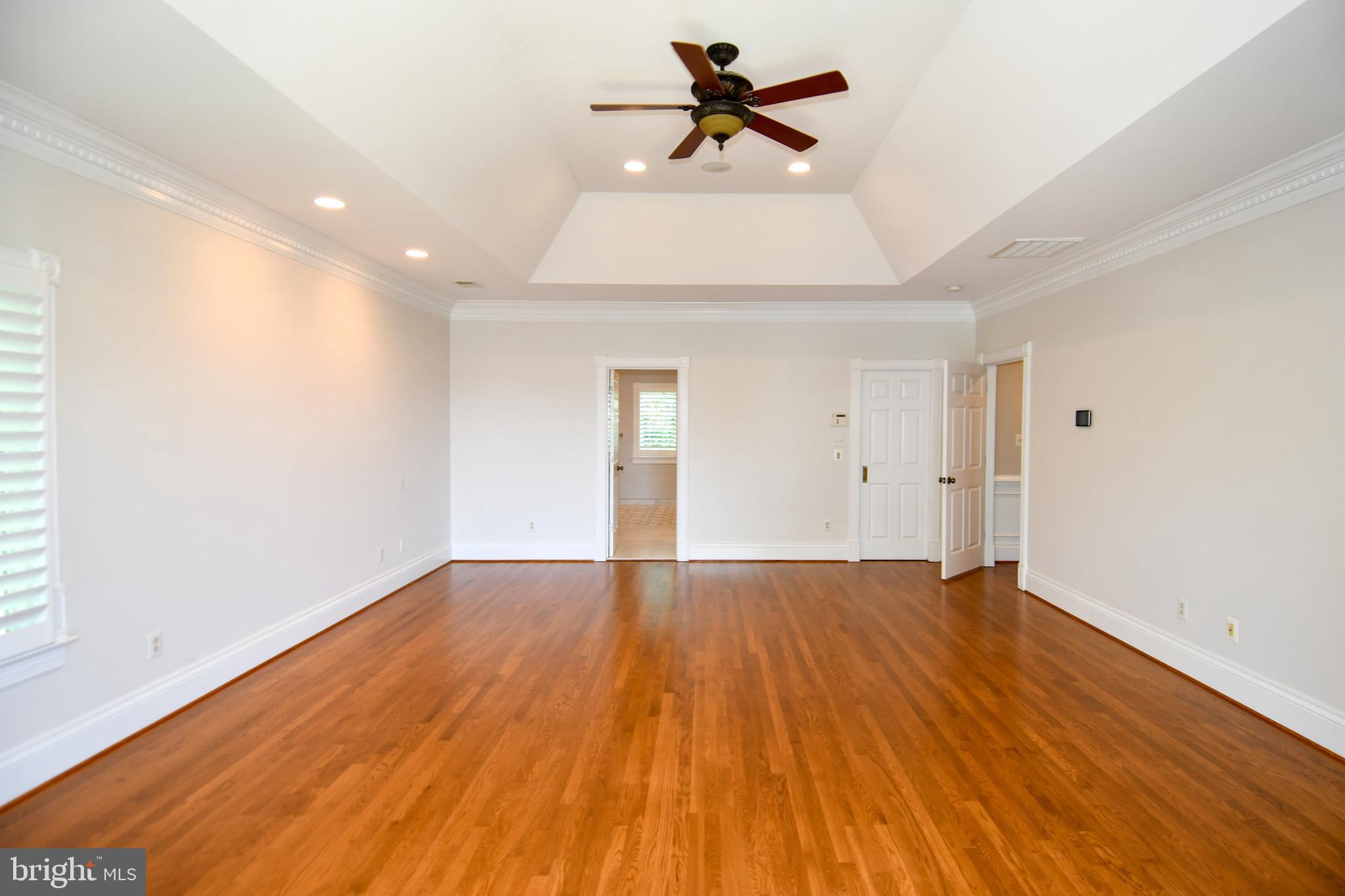7808 Southdown Road Alexandria, VA 22308 - Photo 63 of 99 a view of empty room with wooden floor and fan