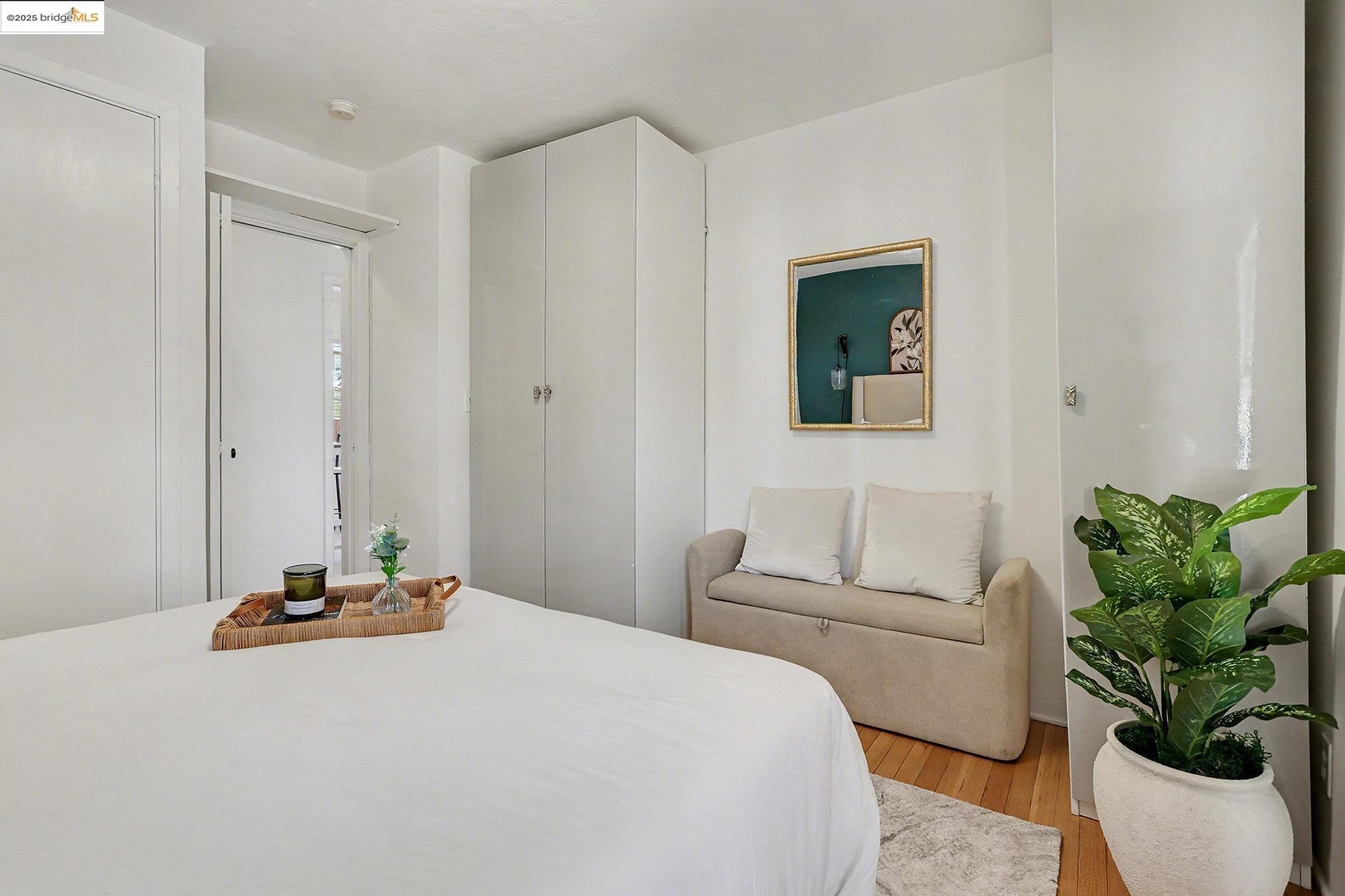 1808 Main Street Alameda, CA 94501 - Photo 12 of 18 a bedroom with a bed a couch and a potted plant