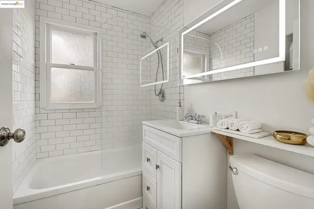 a view of a walk in closet and bathroom