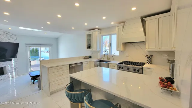 a living room with furniture and kitchen view