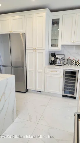 a view of a patio with couches chairs and wooden floor