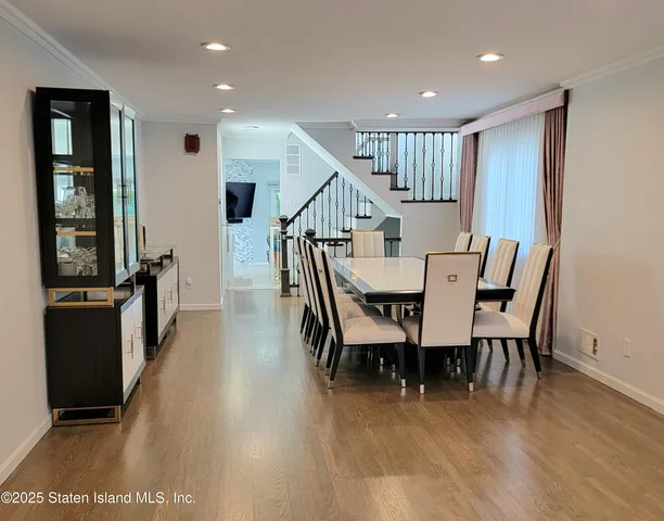 a kitchen with a stove a dining table and chairs