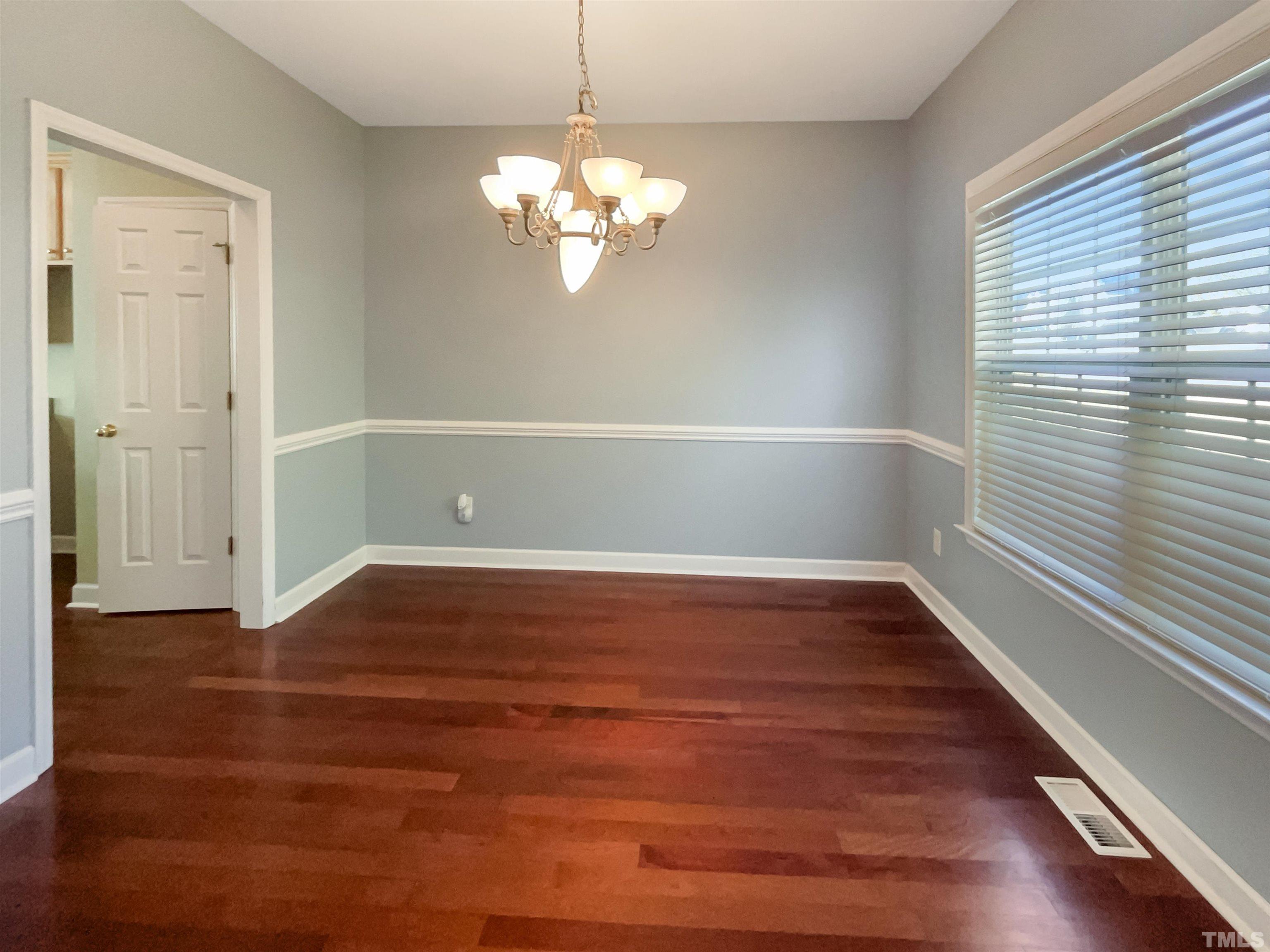 537 Seastone Street Raleigh, NC 27603 - Photo 10 of 25 a view of empty room with wooden floor and fan