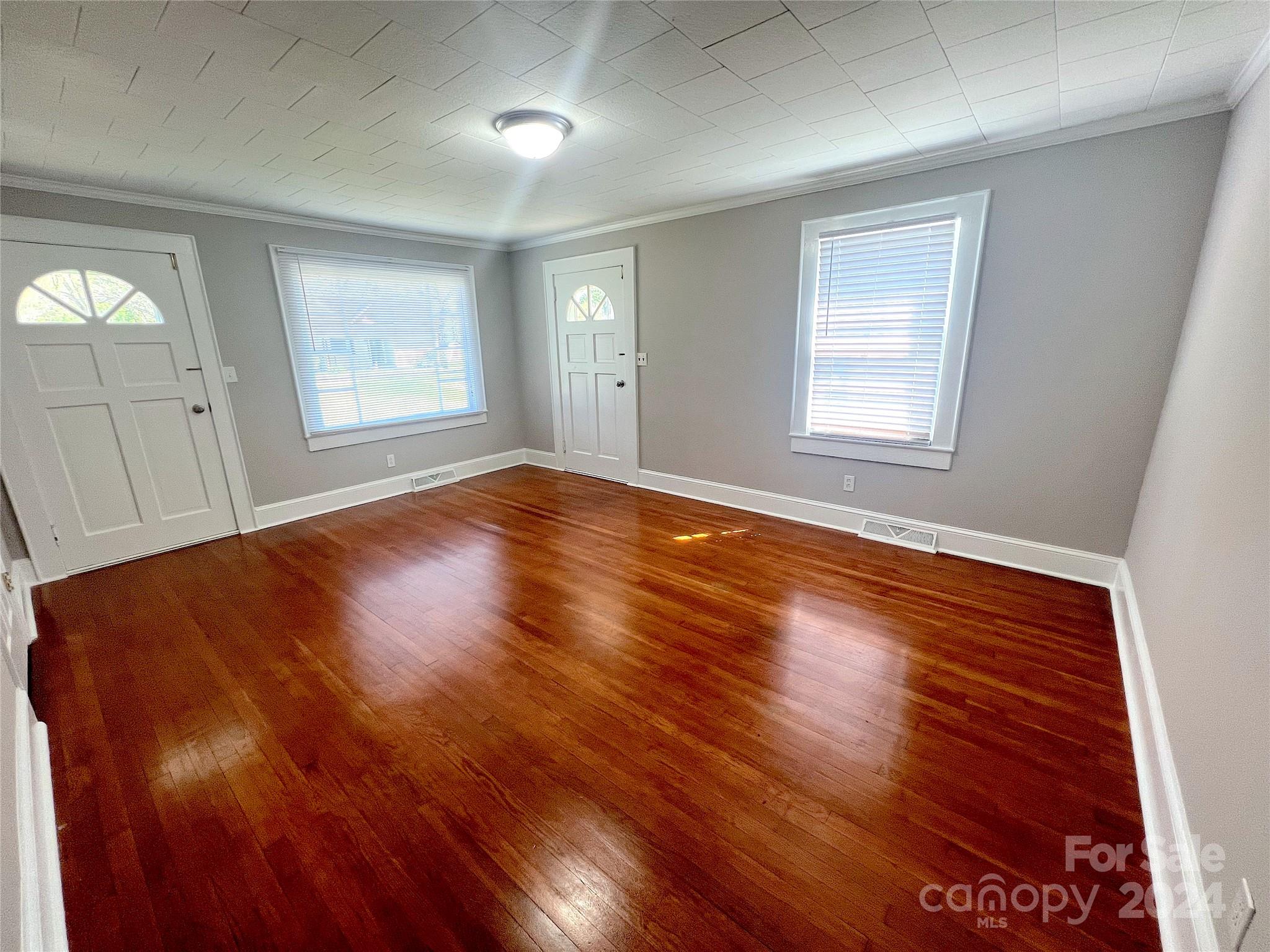 645 Bostian Road China Grove, NC 28023 - Photo 8 of 17 an empty room with wooden floor and windows