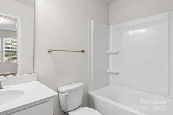 a white bath tub sitting next to a white toilet