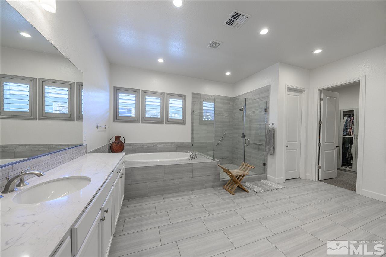 9745 Cardigan Bay Lane Reno, NV 89521 - Photo 13 of 25 a bathroom with a granite countertop sink a toilet and bathtub